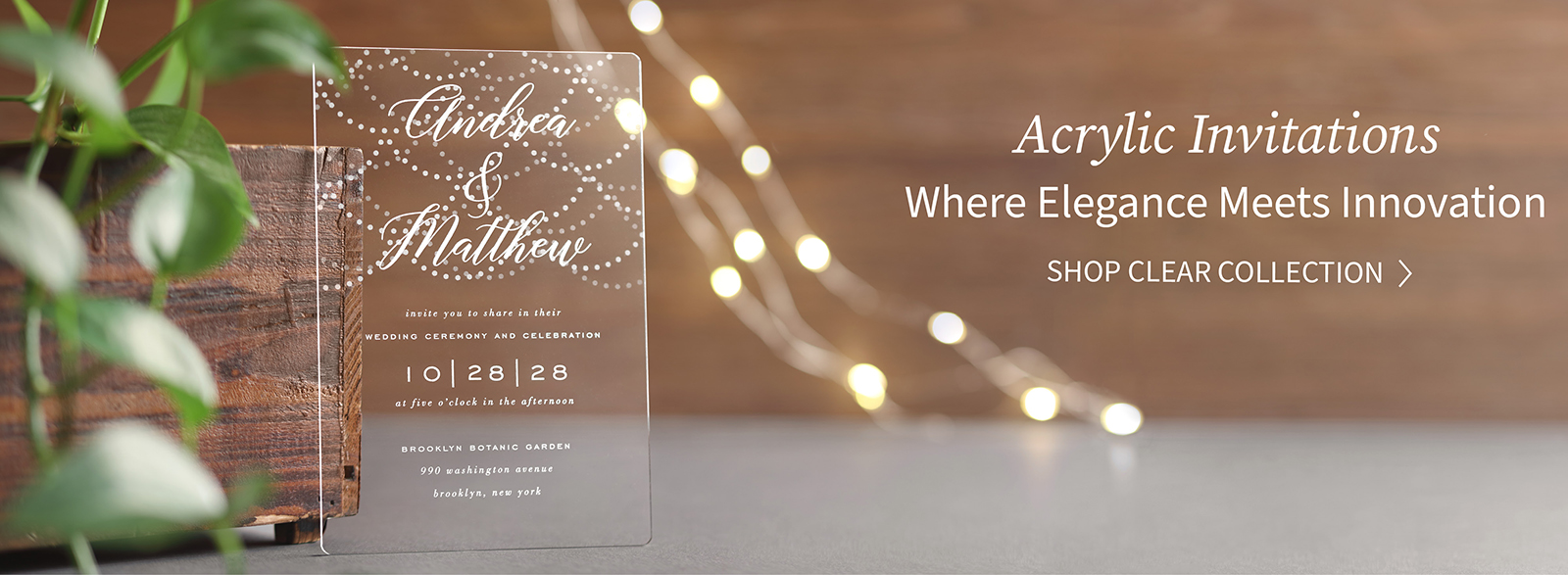 A crystal clear wedding invitation is shown with twinkling lights in the background.